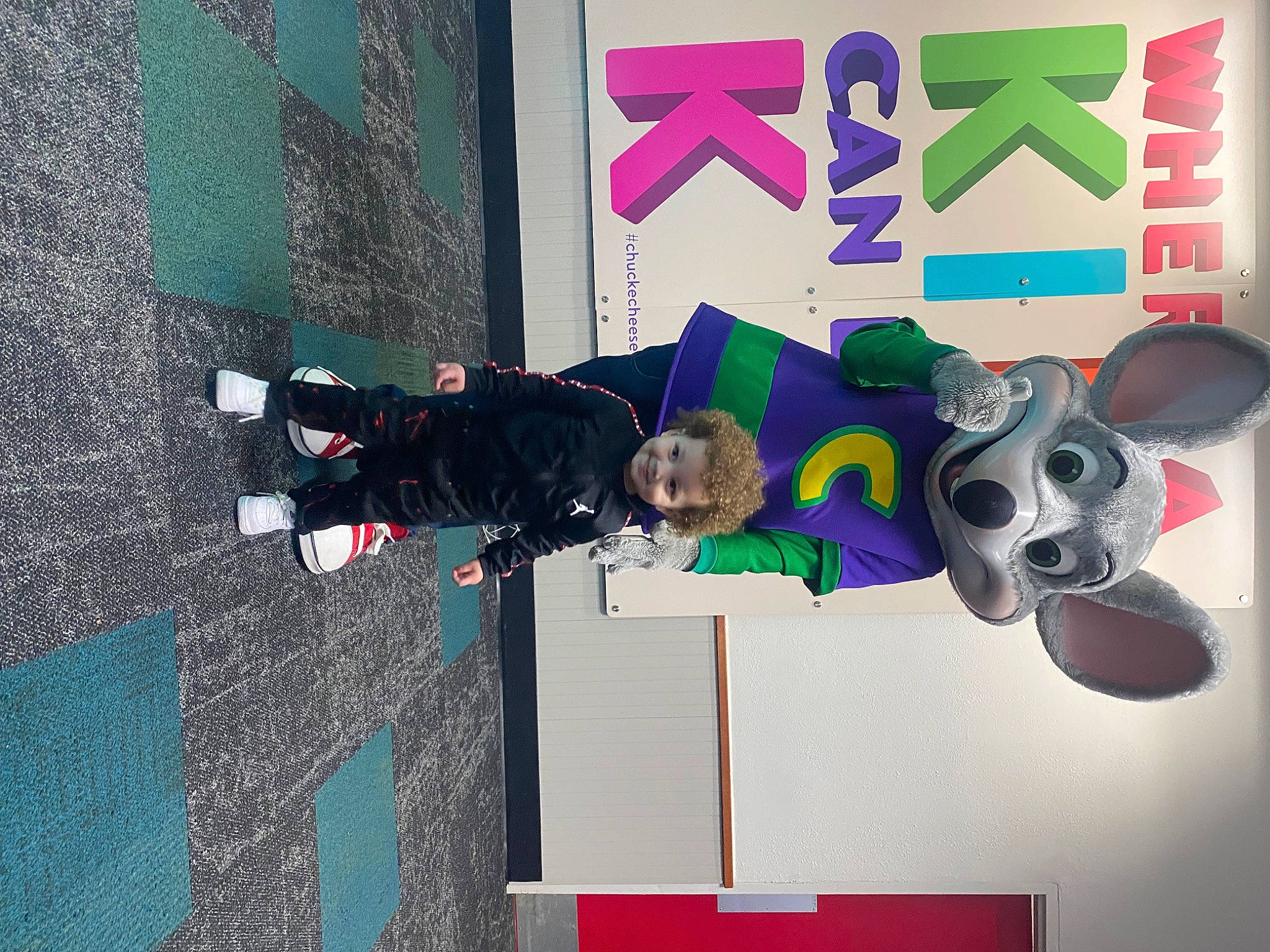 Elijah is registered to the contest to win money with this photo: animation, art, fun, graphics, joy, logo, machine, magenta, person, play, purple, room, space, toddler, toy, visual_arts, walking_shoe, wall