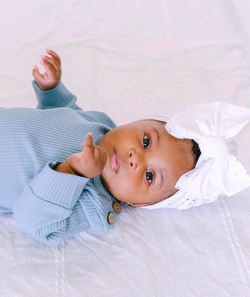Journi is registered to the contest to win money with this photo: baby, baby_toddler_clothing, child, comfort, dress_shirt, elbow, eyelash, gesture, happy, headwear, linens, lip, person, portrait_photography, sitting, sleeve, toddler