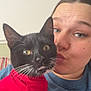 Loki joined the competition — help win amazing prizes! cat, black_cat, red_sweater, person, woman, face, eyes, whiskers, indoor, couch, affection, kiss, closeup, pet, animal, cute, feline, cozy, casual, portrait