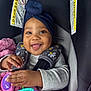 accessories, baby, bodypart, clothing, coat, cushion, face, finger, hand, happy, hat, head, homedecor, jacket, person, photography, portrait, smile, transportation, vehicle