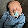 Lucas is registered to the contest to win money with this photo: baby, blue_clothing, child, closeup, comfort, couch, cozy, face, head, indoors, infant, pacifier, peaceful, portrait, relaxed, resting, skin, sleeping, soft_texture, young