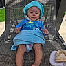 Onyx is registered to the contest to win money with this photo: baby, child, hat, blue_clothing, towel, diaper, outdoor, chair, patterned_fabric, relaxed, smiling, sunny, grass, person, infant, skin, foot, hand, daylight, portrait