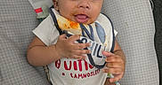 Onyx joined the competition — help win amazing prizes! baby, infant, bib, food_stain, baby_seat, rainbow, animal_print, cute, smiling, happy, child, clothing, indoor, person, small_hands, seat, colorful, playful, face, portrait
