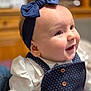Nina a rejoint le concours — aidez-le/la à gagner de superbes lots ! baby, child, headband, bow, smile, happy, polka_dot, clothing, buttons, portrait, face, indoor, cute, infant, apparel, young_child, cheeks, eyes, person, closeup