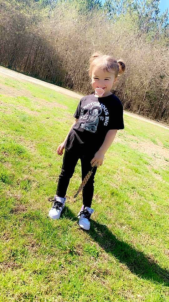 Aspyn is registered to the contest to win money with this photo: fun, gesture, grass, grassland, happy, joy, knee, landscape, lawn, leisure, meadow, pasture, people_in_nature, person, plant, prairie, recreation, running, soil, t_shirt