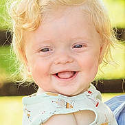 Kolton is registered to the contest to win money with this photo: child, toddler, smiling, blond_hair, curly_hair, shirt, sleeveless, outdoor, daylight, happy, portrait, face, skin, baby, cute, nature, greenery, background, expression, person