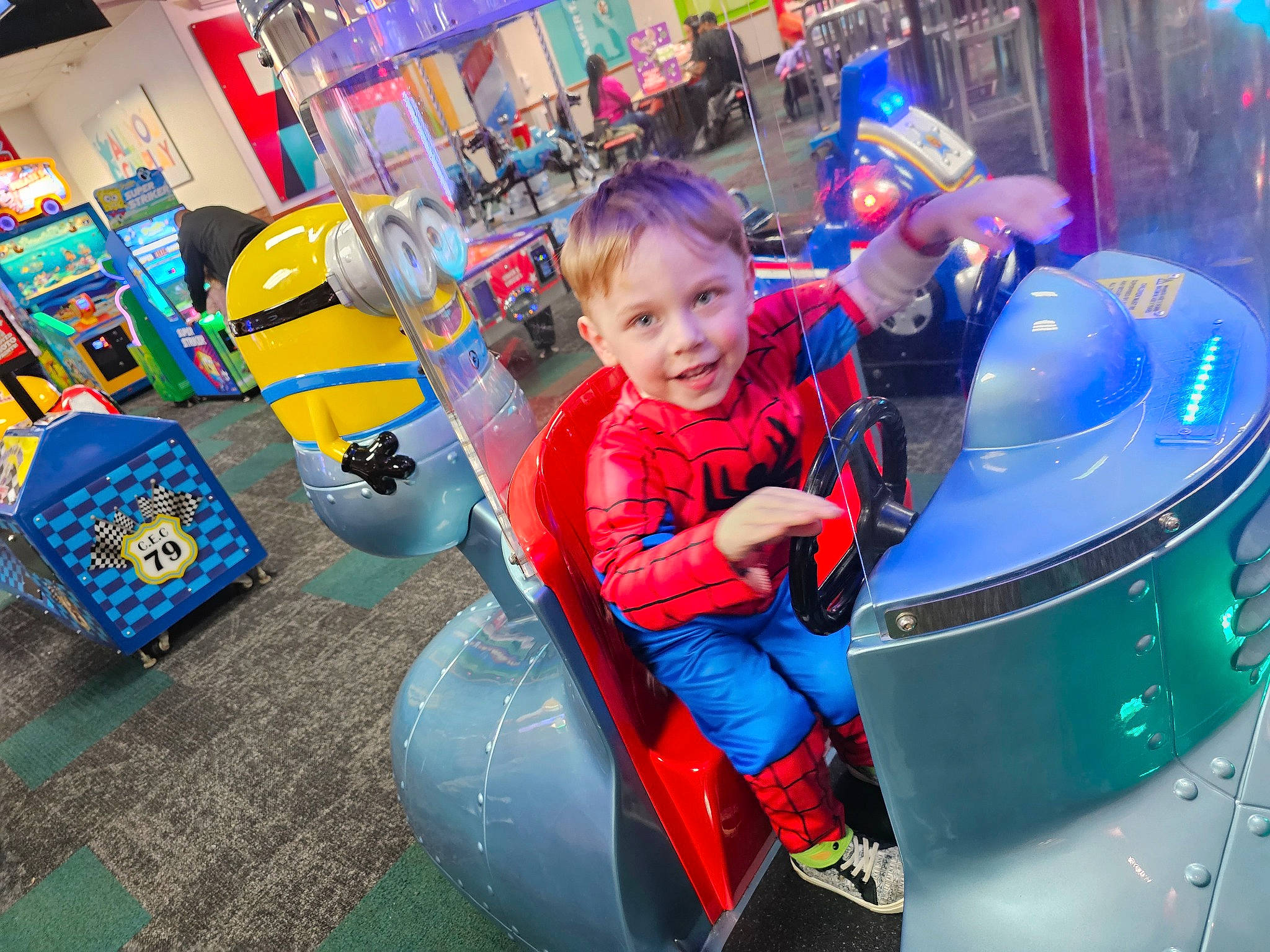 Lance is registered to the contest to win money with this photo: amusement_park, amusement_ride, blue, child, city, drum, electric_blue, event, fun, games, green, inflatable, joy, leisure, machine, motor_vehicle, person, play, recreation, t_shirt