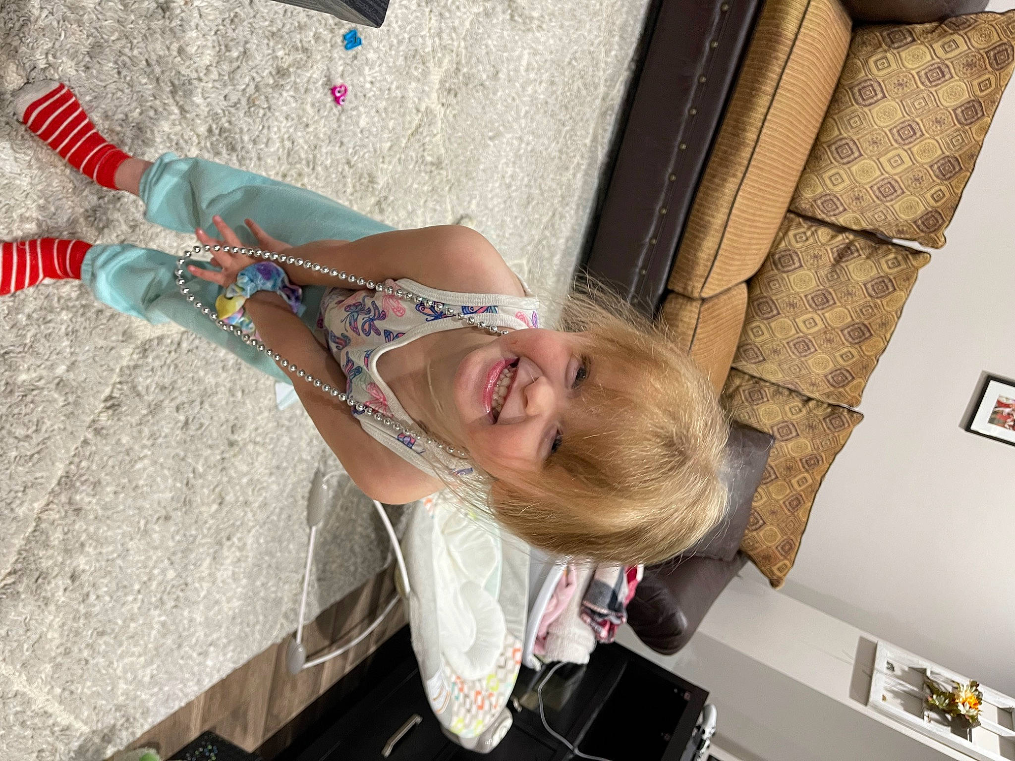 Denver is registered to the contest to win money with this photo: arm, child, dress, elbow, foot, fun, happy, human_leg, joy, leisure, person, sandal, smile, street_fashion, thigh, vacation, wrist