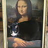 cat, mona_lisa, painting, frame, black_and_white, animal, portrait, art, wooden_floor, indoor, feline, curious, whiskers, collar, classic, hands, expression, decor, humor, fusion