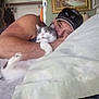 Bama joined the competition — help win amazing prizes! man, cat, bed, pillow, blanket, cap, sunglasses, painting, indoor, cuddling, pet, feline, resting, comfortable, household, arm, face, fur, animal, cozy