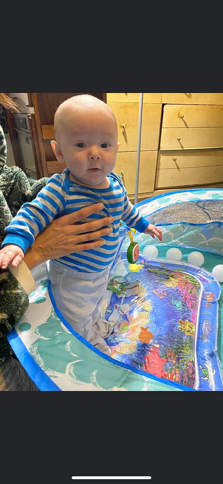 Jonathan is registered to the contest to win money with this photo: azure, baby, baby_products, baby_toddler_clothing, child, electric_blue, flooring, fun, happy, leisure, linens, pattern, person, play, product, recreation, sitting, sleeve, toddler, visual_arts