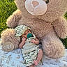 Luis is registered to the contest to win money with this photo: baby, teddy_bear, pacifier, blanket, grass, outdoor, infant, hat, clothing, cute, one_month, pattern, toy, sunlight, milestone, soft, relaxing, small, child, nature