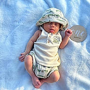 Luis joined the competition — help win amazing prizes! baby, newborn, infant, hat, clothing, blanket, blue, sign, wooden, one_month, sleeping, cute, milestone, portrait, baby_clothes, soft_texture, resting, peaceful, small_hand, lying_down