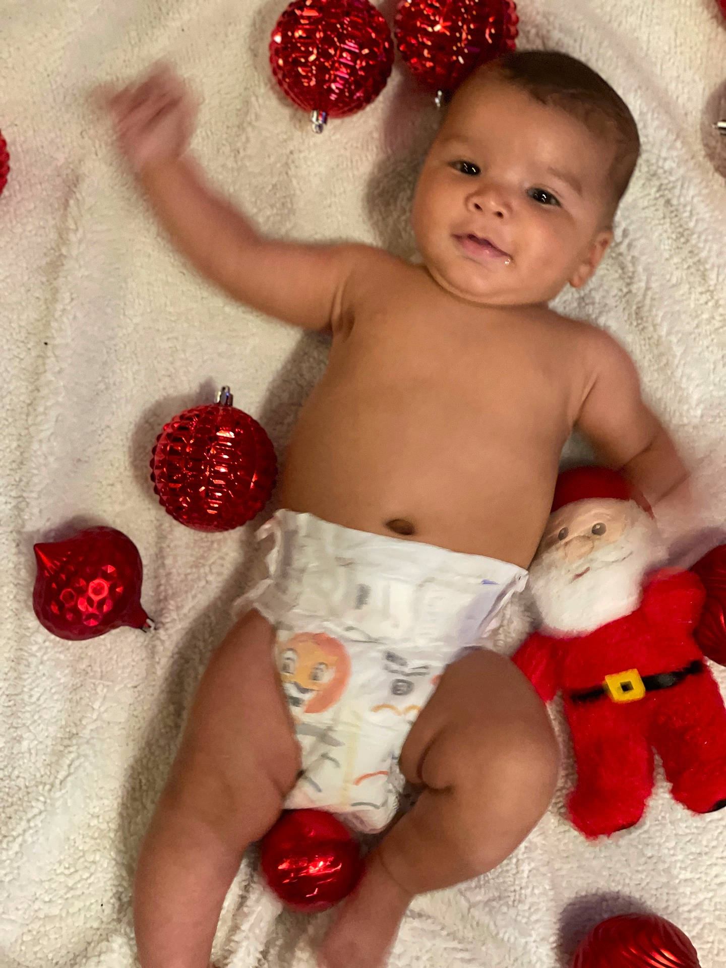 baby, bathing, blanket, bodypart, clothing, diaper, face, finger, hand, happy, head, newborn, person, photography, portrait, quilt, sitting, smile, standing, toy