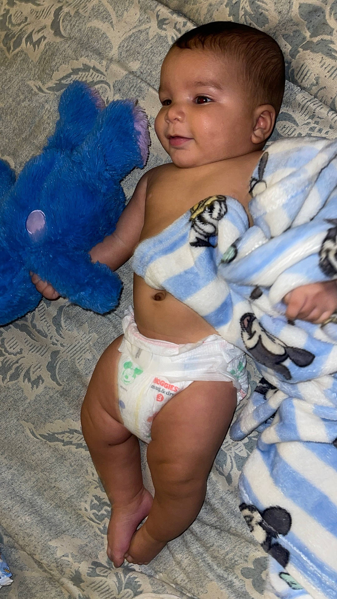 baby, bed, bedroom, blanket, bodypart, couch, diaper, face, finger, furniture, hand, head, homedecor, indoors, newborn, person, photography, portrait, quilt, toy