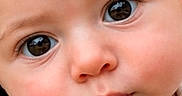 Giada joined the competition — help win amazing prizes! baby, big_eyes, child, close_up, clothing, curious, cute, expression, face, floral_pattern, head, human, innocent, person, portrait, rosy_cheeks, skin, soft_lighting, white_outfit, young_child