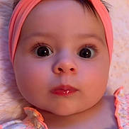 Giada is registered to the contest to win money with this photo: baby, baby_girl, child, close_up, clothing, curious_expression, cute, eyelashes, face, headband, headwear, indoors, infant, person, pink, portrait, skin, soft_blanket, wide_eyes, young