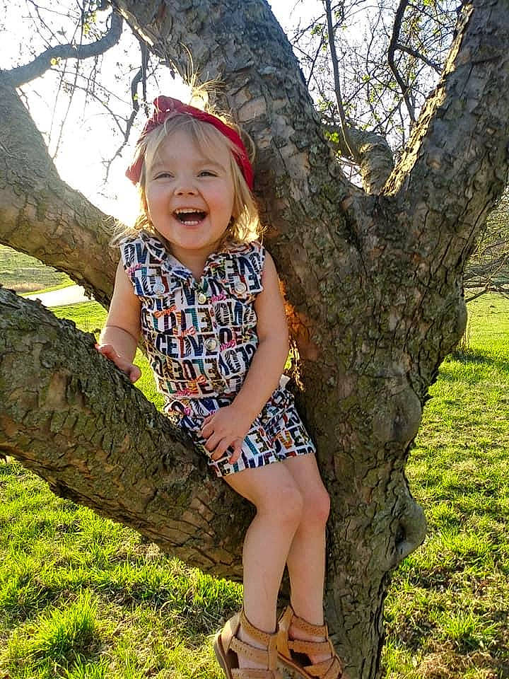 Lucille joined the competition — help win amazing prizes! branch, child, child_model, dress, grass, joy, pattern, person, photography, plant, smile, toddler, tree, trunk, woody_plant