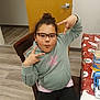 Mia Overton is registered to the contest to win money with this photo: accessories, adult, bodypart, couch, face, female, finger, furniture, glasses, hand, hardwood, head, indoors, interiordesign, person, photography, plywood, portrait, woman, wood