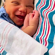 Ka'Moni joined the competition — help win amazing prizes! newborn, baby, smiling, wrapped, blanket, striped, sleeping, face, hand, cute, infant, soft, peaceful, cozy, portrait, closeup, child, sleep, rest, happy
