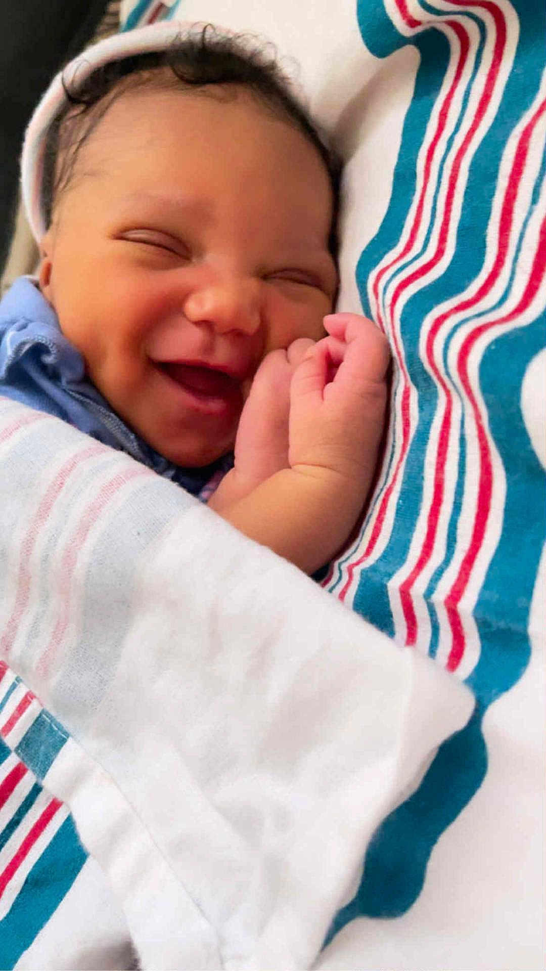 Ka'Moni joined the competition — help win amazing prizes! newborn, baby, smiling, wrapped, blanket, striped, sleeping, face, hand, cute, infant, soft, peaceful, cozy, portrait, closeup, child, sleep, rest, happy