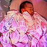 Jocelyn is registered to the contest to win money with this photo: baby, sleeping, pink, onesie, blanket, crib, mesh, infant, child, cozy, peaceful, floral_pattern, fabric, soft, portrait, indoors, cute, resting, young_child, bedtime