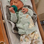 Wyatt is registered to the contest to win money with this photo: newborn, baby, sleeping, pacifier, hat, clothing, blanket, hospital, bassinet, infant, cute, pastel, soft, peaceful, child, person, sleep, rest, small, wrapped