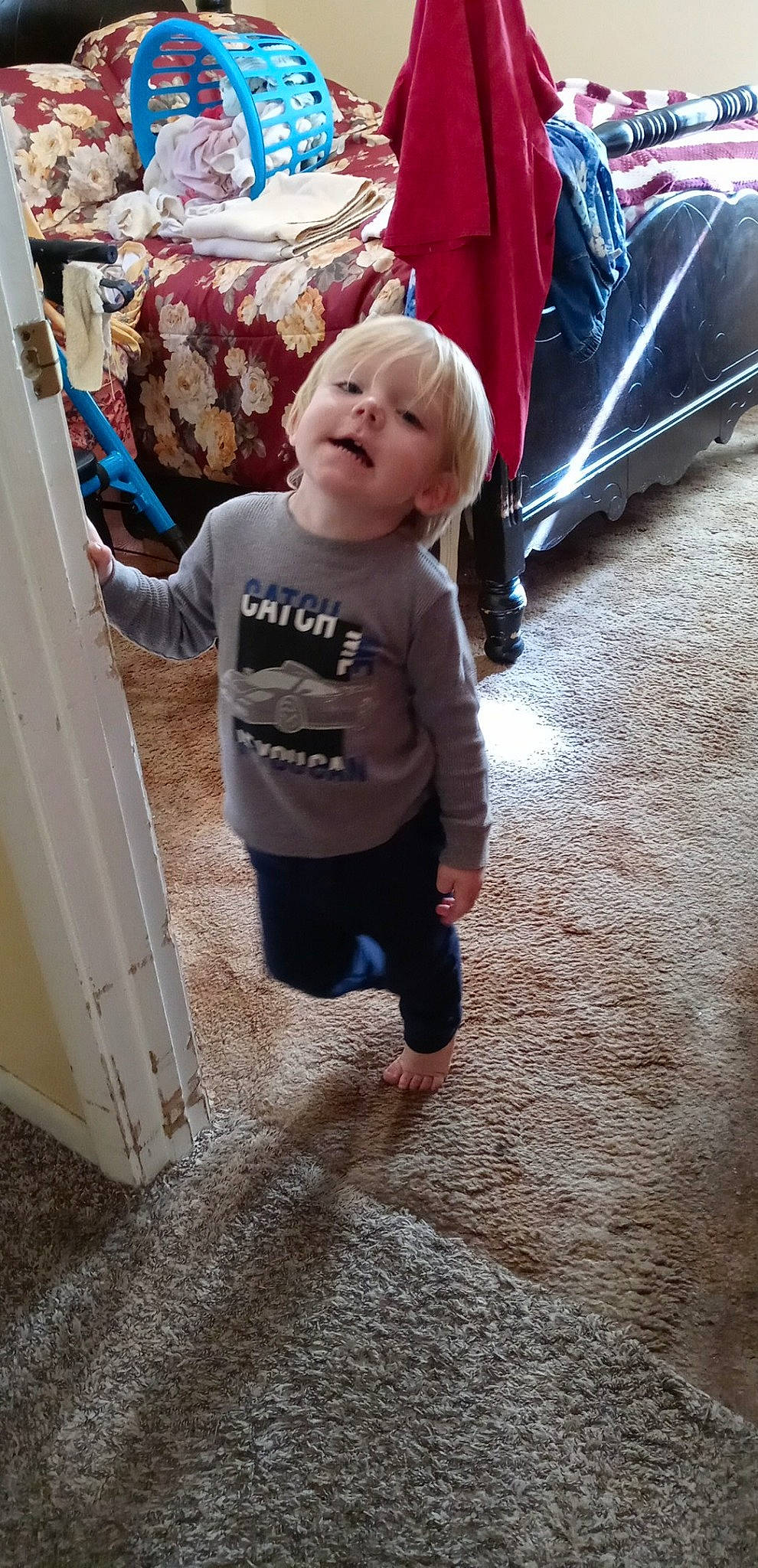 Trayse is registered to the contest to win money with this photo: baby, baby_toddler_clothing, backpack, child, floor, flooring, fun, happy, head, human_body, leisure, pattern, person, recreation, sitting, sleeve, smile, standing, t_shirt, toddler