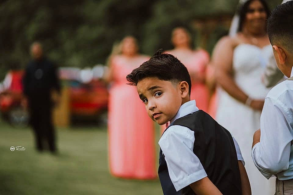 Dereck is registered to the contest to win money with this photo: blurred, ceremony, child, crowd, event, formal_wear, fun, happy, leisure, people, person, photography, smile, under_exposed, wedding, youth