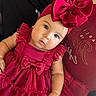 baby, child, red_dress, headband, bow, cute, portrait, indoor, infant, person, sitting, fashion, clothing, baby_girl, adorable, young_child, face, eyes, skin, background