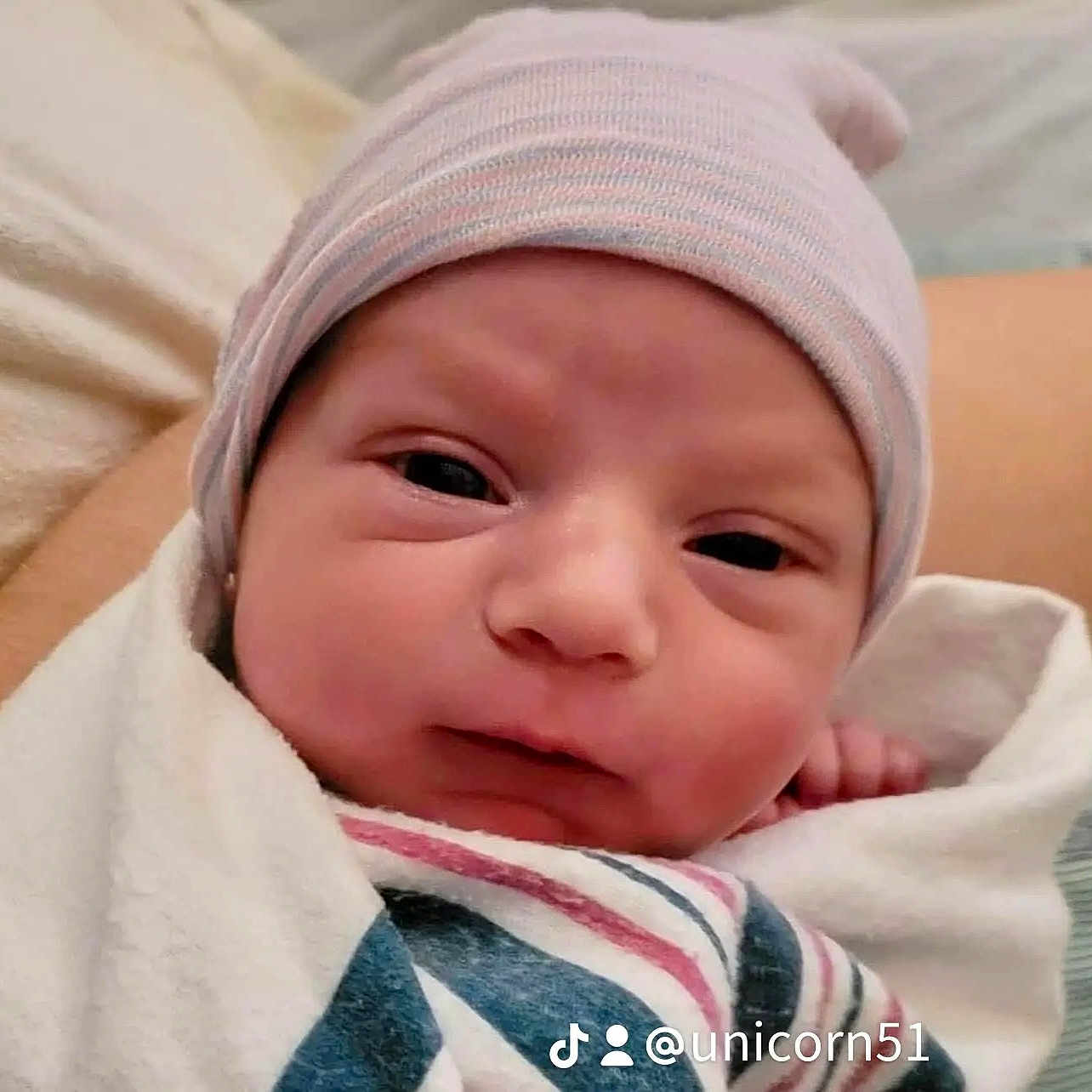 Carter is registered to the contest to win money with this photo: baby, beanie, bonnet, cap, clothing, crying, face, happy, hat, head, newborn, person, photography, portrait, sad, smile