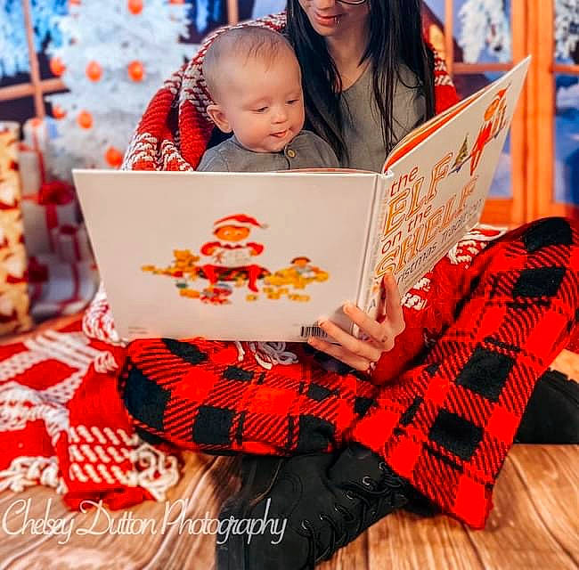 Silas joined the competition — help win amazing prizes! beauty, book, child, christmas, event, fashion, fun, happy, human, leisure, orange, pattern, people, person, plaid, publication, red, sitting, tartan, textile