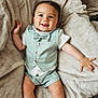 baby, baby_boy, blanket, bowtie, casual, child, clothing, cute, happy, heart_emoji, indoors, infant, person, portrait, shorts, sitting, smiling, soft_texture, tongue_out, vest