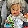 baby, child, car_seat, bib, toy, colorful, soft_toy, clothing, curious, face, hand, indoor, infant, person, portrait, seat_belt, expression, young, cute, casual