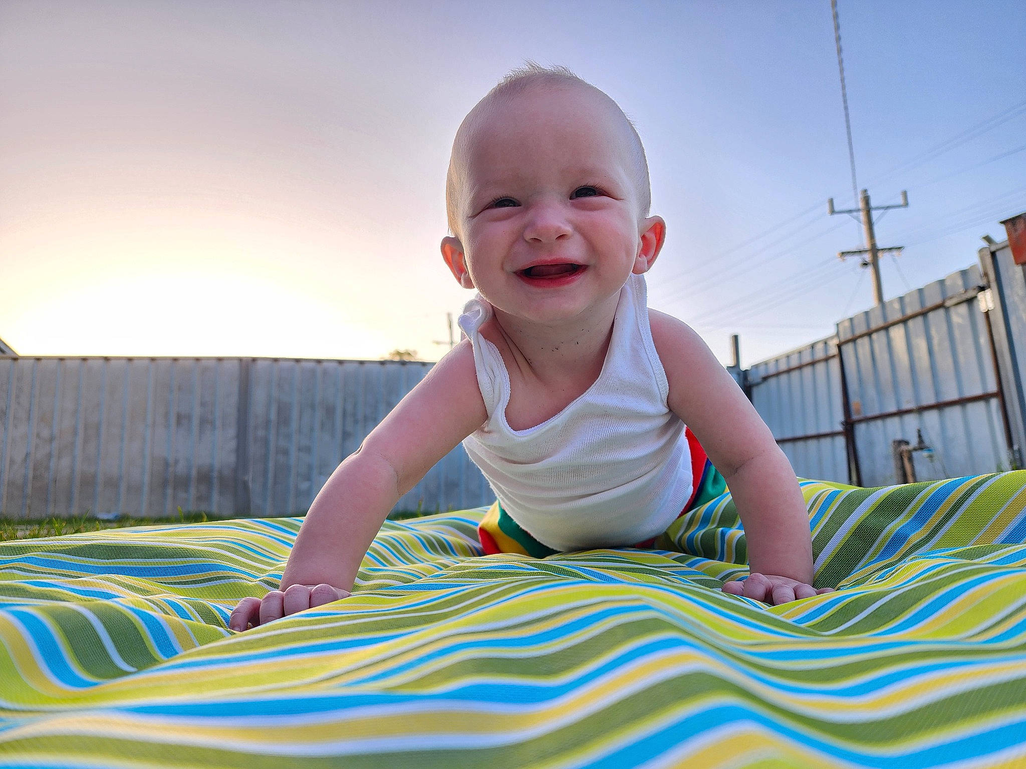 Clayton is registered to the contest to win money with this photo: baby, baby_laughing, baby_toddler_clothing, beauty, child, comfort, crawling, fun, grass, happy, joy, leisure, pattern, people_in_nature, person, product, recreation, sitting, skin, sky