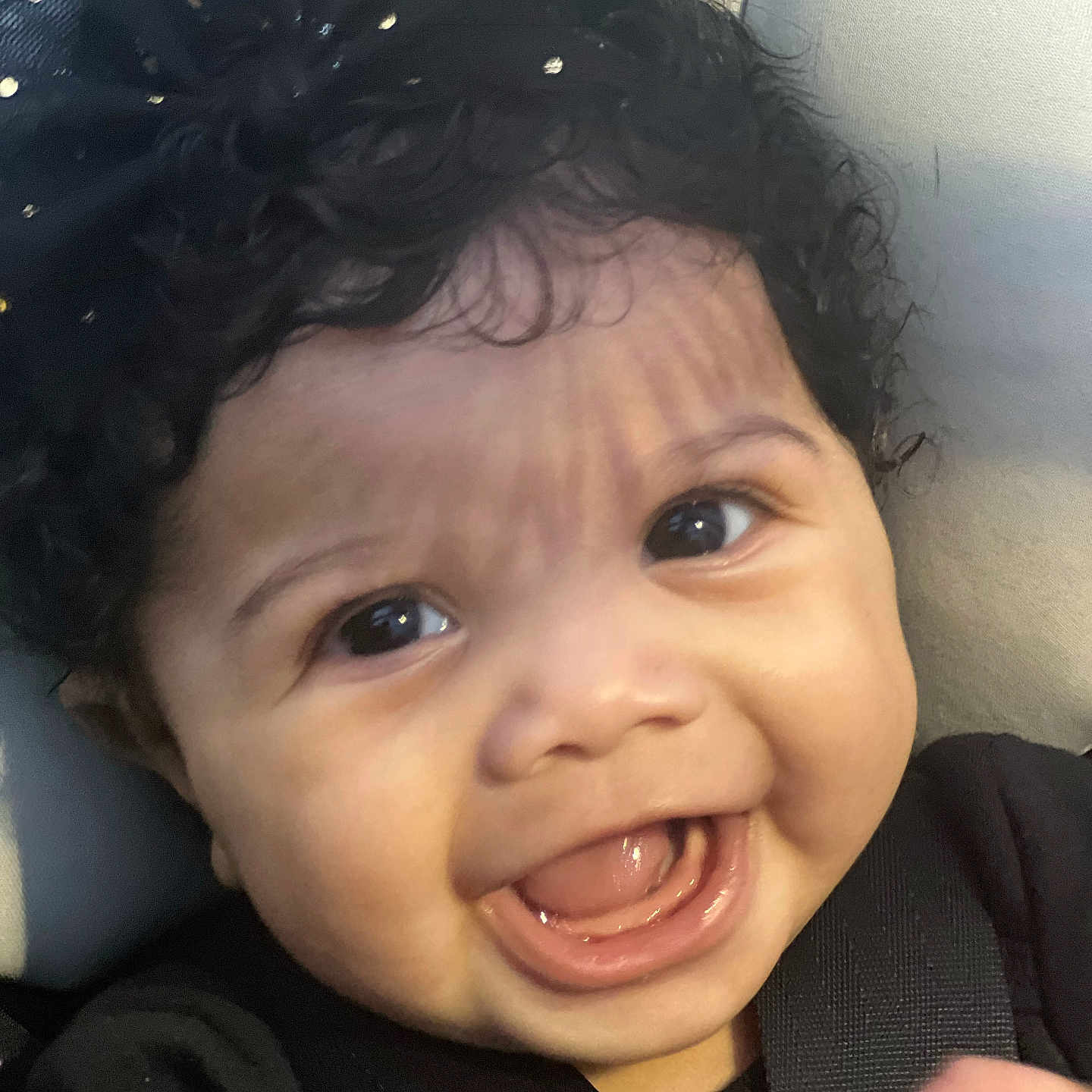 Sage is registered to the contest to win money with this photo: baby, babylaughing, blackhair, bodypart, clothing, coat, dress, face, hair, happy, head, jacket, laughing, mouth, person, photography, portrait, selfie, smile, teeth