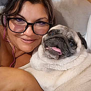 Lizzy participe au concours pour gagner de l'argent avec cette photo : woman, dog, pug, glasses, smile, tongue, pet, couch, indoor, face, closeup, happy, friendship, snuggle, cozy, brown_hair, earphones, skin, expression, portrait
