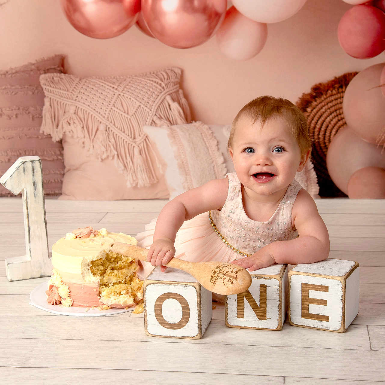 Freya joined the competition — help win amazing prizes! baby, balloons, birthday, cake, celebration, child, cute, decor, dress, face, floor, happy, indoors, milestone, number_one, pillow, pink, smiling, spoon, wooden_blocks
