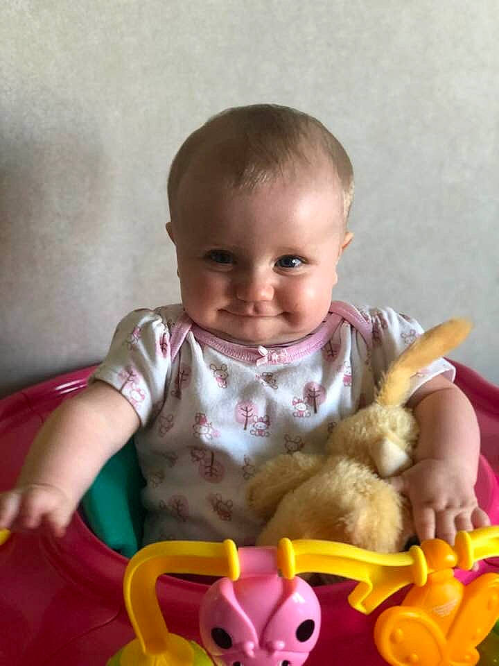 Mia is registered to the contest to win money with this photo: baby, baby_toys, cheek, child, eye, finger, fun, hand, head, joy, mouth, nose, person, pink, play, product, sitting, skin, stuffed_toy, toddler