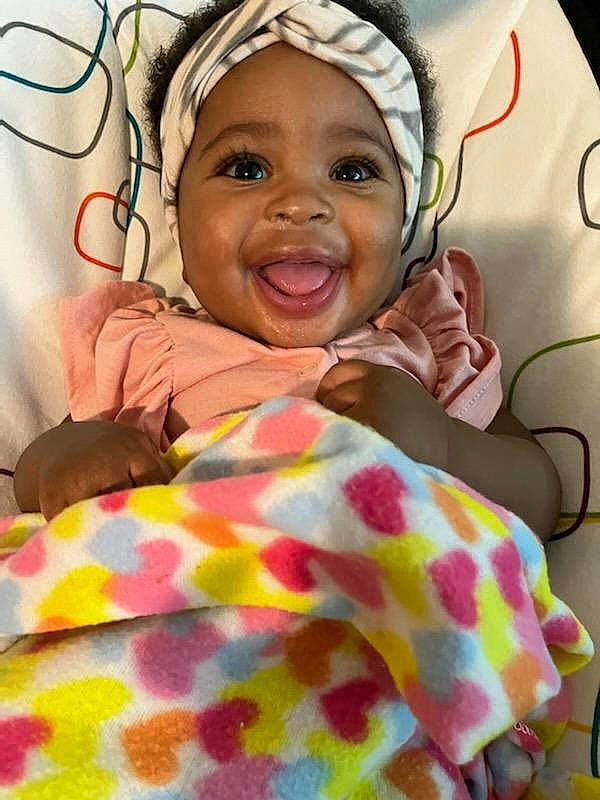 Amiyah joined the competition — help win amazing prizes! baby, baby_sleeping, cheek, comfort, eye, eyebrow, face, happy, headwear, linens, lip, mouth, nose, orange, organ, person, pink, product, skin, smile