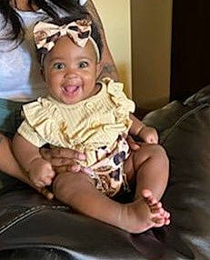 Amiyah joined the competition — help win amazing prizes! baby, baby_products, baby_toddler_clothing, car_seat, chair, comfort, ear, event, eye, finger, hair_accessory, happy, headgear, headwear, iris, joy, lap, person, sitting, smile