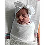 baby, blanket, bow, child, closeup, cute, face, headband, indoors, infant, newborn, peaceful, portrait, resting, sleeping, soft, swaddled, towel, white, wrapped