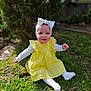 Aurora is registered to the contest to win money with this photo: baby, child, smiling, yellow_dress, headband, bow, grass, outdoor, garden, sunlight, happy, toddler, white_tights, cute, portrait, nature, greenery, sitting, face, rosy_cheeks