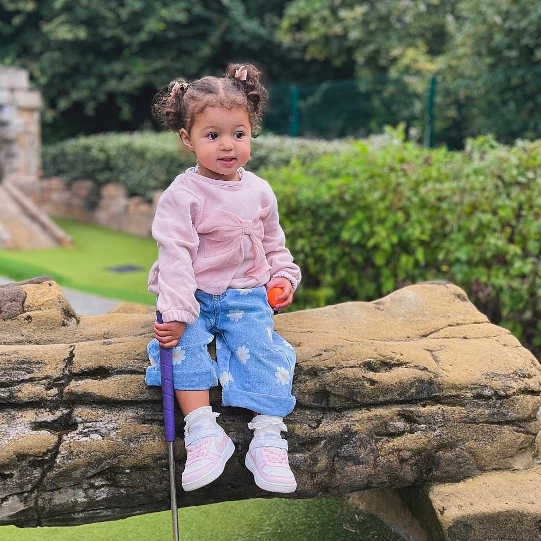 Aayla-Louise joined the competition — help win amazing prizes! blue_jeans, casual_clothing, child, curly_hair, girl, golf_ball, greenery, mini_golf, nature, outdoor, park, pigtails, pink_sweater, playground, putter, recreation, shoes, stone_bridge, toddler, young_child