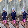 toddler, child, outdoor, playful, pink_boots, navy_jumpsuit, white_hat, pom_pom, wooden_fence, smiling, happy, cute, posing, playground, ground, sidewalk, nature, seasonal_clothing, fun, portrait