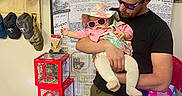 Amyra is registered to the contest to win money with this photo: accessories, adult, baby, bearded_man, cargo_pants, cowhide_rug, decor, happy, hats_display, holding, indoor, love_blocks, pink_outfit, portrait, stacked_boxes, store_display, sunglasses, sunhat, toy, valentines_sign
