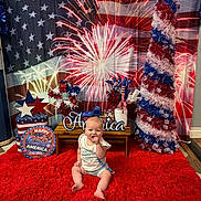 Amyra joined the competition — help win amazing prizes! american_flag, anniversary, baby, beads, celebration, child, colorful, decoration, festive, fireworks, floor, happy, holiday, indoor, patriotic, portrait, red_rug, sitting, table, toy