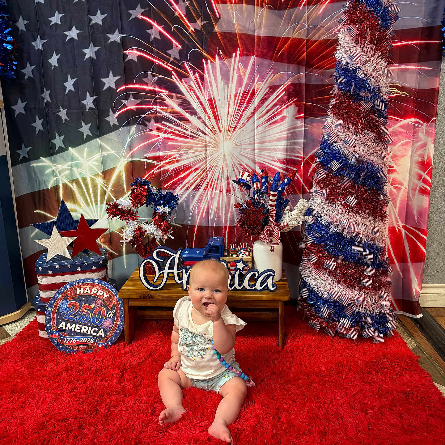 Amyra joined the competition — help win amazing prizes! american_flag, anniversary, baby, beads, celebration, child, colorful, decoration, festive, fireworks, floor, happy, holiday, indoor, patriotic, portrait, red_rug, sitting, table, toy