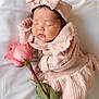 adorable, baby, bow, child, cozy, cute, face, flower, hand, headband, infant, knitted_clothing, peaceful, pink, portrait, resting, rose, sleeping, soft_texture, white_blanket