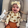 baby, smiling, infant, headband, polka_dot, knitted_pants, baby_seat, straps, cute, happy, clothing, child, portrait, indoors, cushion, person, seat, apparel, headwear, baby_fashion